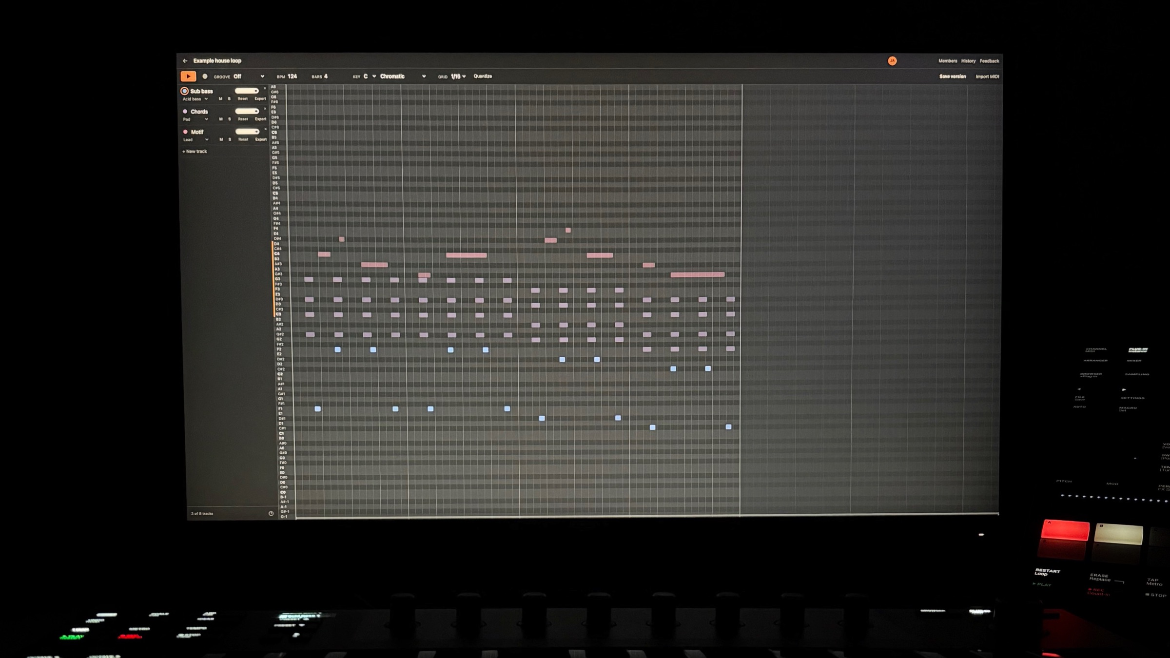 Jam open on a monitor in a dark room: a four-bar house loop with a bassline, chords and a motif on separate coloured tracks, and a MIDI keyboard and a controller lit up in front of it.